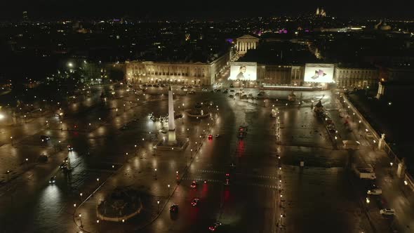 AERIAL: Flight Over Place De La Concorde in Paris, France at Night with Wet Reflecting Ground and