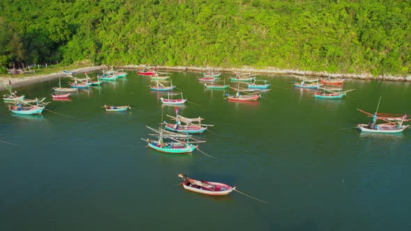 Many fishing boats on the coast beside the mountains, beautiful sea area in Thailand.