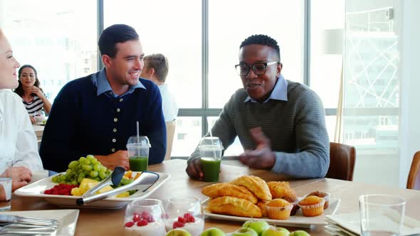 Executives interacting while having meal