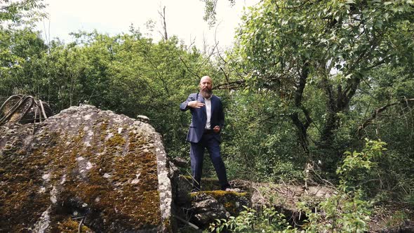 Businessman practicing martial arts barefoot in nature