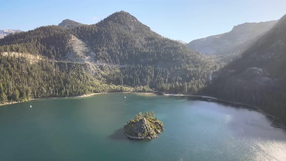 Drone shot flying backwards away from Fannette Island and Eagle falls. Granite Chief Wilderness in t