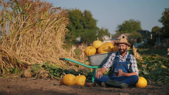 Farmer Resting Near a Car with Pumpkins