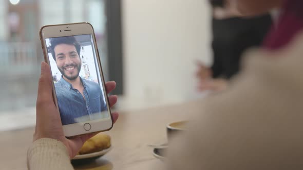 Video call. Close up hand with video chat on mobile phone screen