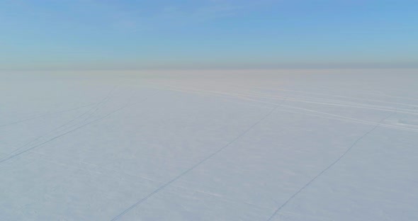 Aerial View of Cold Winter Landscape Arctic Field Trees Covered with Frost Snow Ice River and Sun