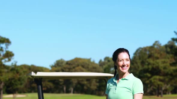 Happy female golfer playing golf