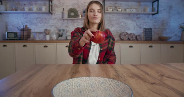 The Girl Is Takes the Last One Apple From the Plate. 