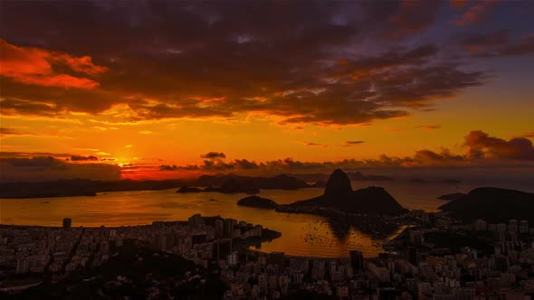 Sunrise time-lapse of Sugar Loaf mountain from behind Rio.