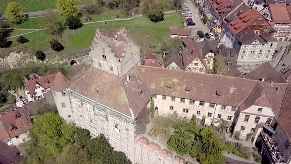 Medieval Meersburg Castle aerial drone view close up shot of roof.