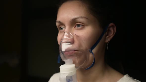 Close-up of the face of a young woman who treats the respiratory tract