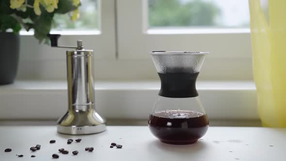 Filtering Coffee in Reusable Glass Coffee Maker