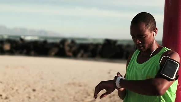 Man using smartwatch on the beach