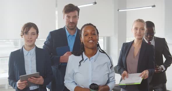 Portrait of Mixed Race Business Team in Office Posing at Camera