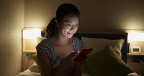 Woman use of mobile phone at night