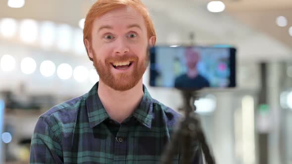 Creative Beard Redhead Man Recording Video on Smartphone