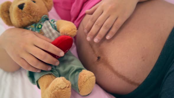 Happy Pregnant Woman Sleeping on Bed in Bedroom