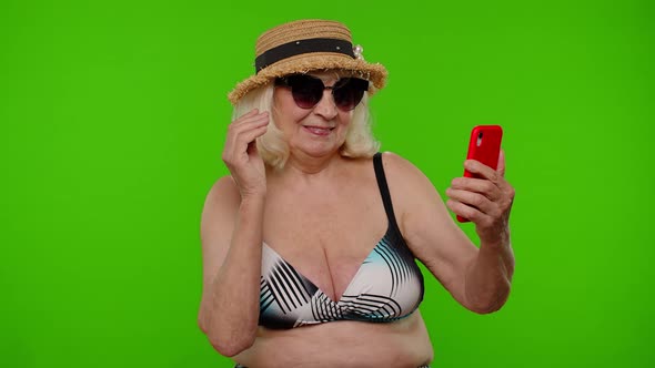 Mature Woman Traveler Blogger in Sunglasses Taking Selfie Portrait Photo Video Call on Smartphone