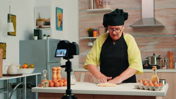 Old Woman Recording Food Video in Kitchen