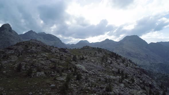 Moving Backward Above Rock Mountain in Evening Summer Day