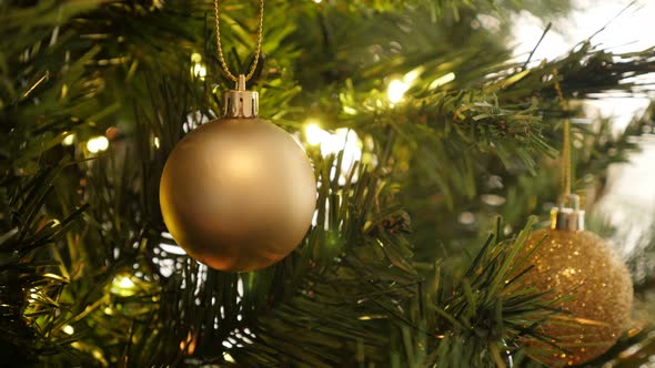 Golden Christmas ornament close-up 4K 2160p 30fps UltraHD footage - Gold color  bauble on the tree 3