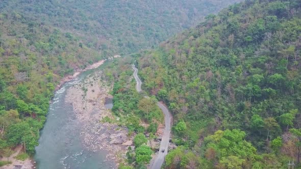 High Aerial View Rocky River and Road Between Tropical Forests