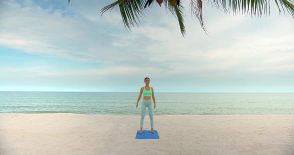 Sport Woman Makes Morning Squats on the Beach Morning Fitness Exercise