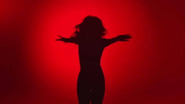 Black Silhouette of Seductive Woman Dancing Raising Hands Demonstrate Dance