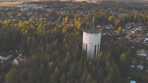 Drone flying away from water tower.