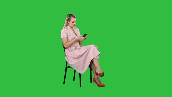 Young Woman with blond hair sitting on a chair reading