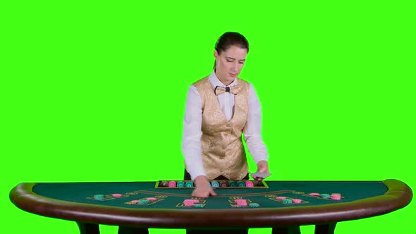 Casino Croupier in a White Shirt Distributes for Table Poker Three Cards Are the Flop. Green Screen