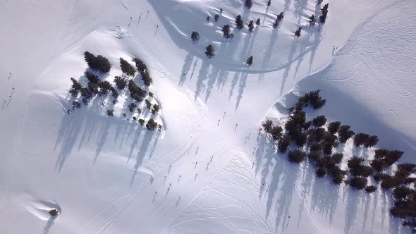 Aerial view of People Skiing and snowboarding on hill, Ski Resort. Drone flies over Skiers Skiing do