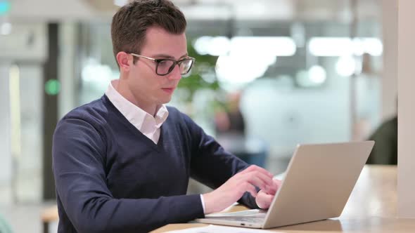 Serious Young Businessman with Laptop Saying No with Finger Sign