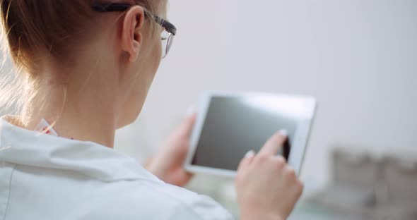 Female Doctor Using Digital Tablet at Dental Clinic