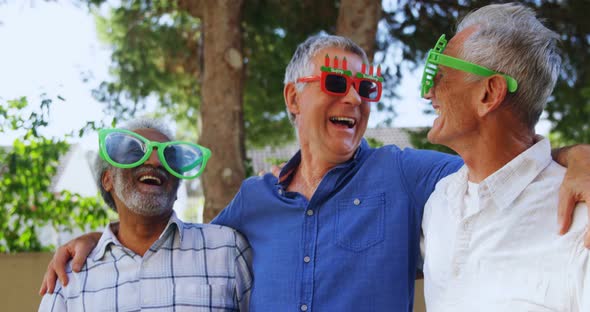 Senior friends wearing party props