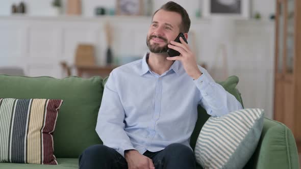 Young Man Talking on Phone at Home