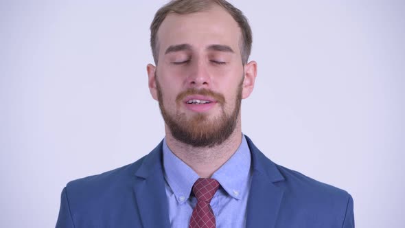 Face of Happy Bearded Businessman Relaxing with Eyes Closed