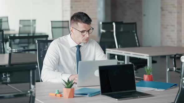 Forworn Manager Sitting at Workspace