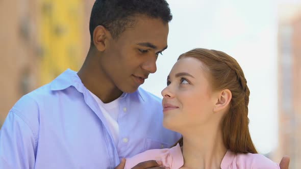 Young Black Male Tenderly Hugging Red-Haired Girlfriend, Couple Enjoying Date