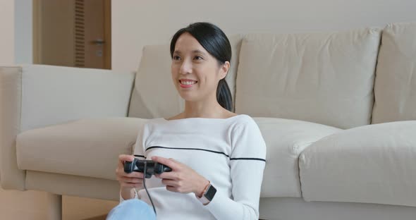 Woman play tv game at home