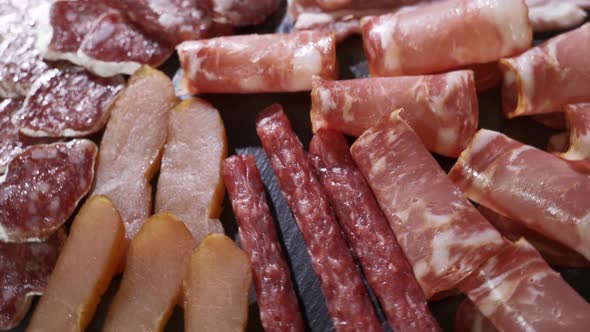 Salami and Chorizo Sausage Close Up on Stone Serving Board