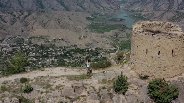 Mountain Landscape and a Running Girl To the Old Destroyed Tower