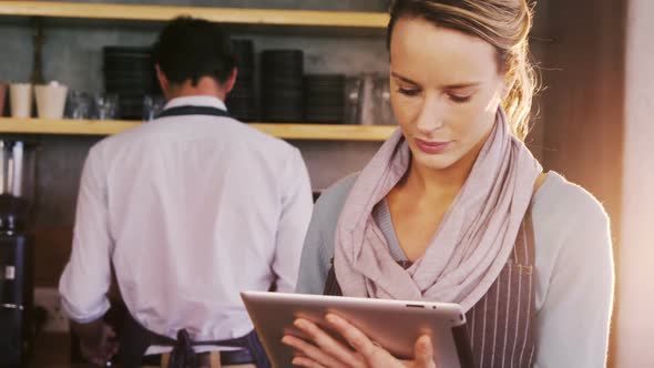 Waiter and waitress looking back and talking to each other