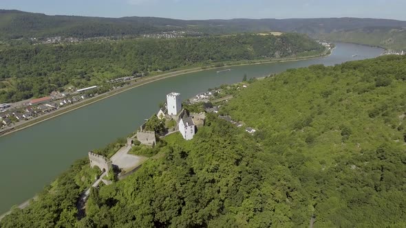 Drone flies smoothly over a castle on a mountain.