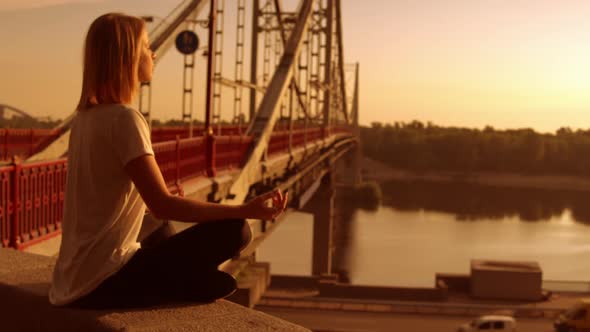 Woman Is Sitting By the Bridge