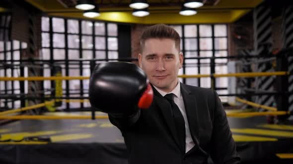 Portrait of a Happy Businessman in a Boxing Gloves in a Boxing Ring He Dances