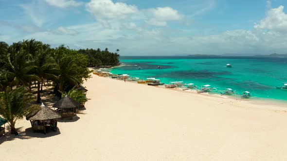 Tropical Daco Island with a Sandy Beach and Tourists