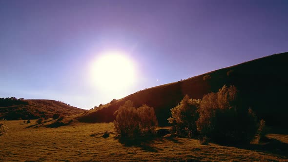  UHD Mountain Meadow Timelapse at the Summer. Clouds, Trees, Green Grass and Sun Rays Movement.