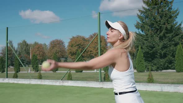 Pro Tennis Player Hits the Ball with a Racket Practice Game on the Tennis Court Young Woman Serving