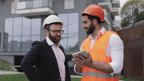 Construction Manager and Architect Man Are Discussing the Construction Plan of the Modern Business