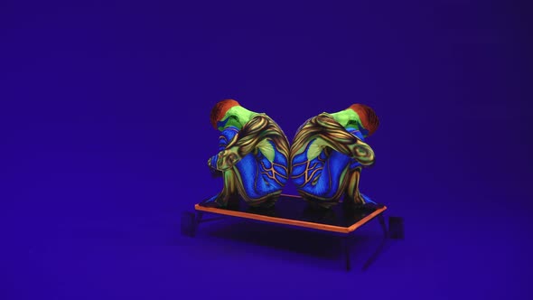 Twins In Neon Alien Luminous Costumes Sit Back To Back