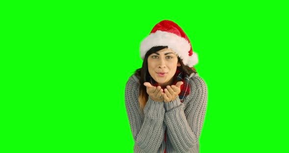 Woman in santa hat and warm clothing blowing over hands 4k